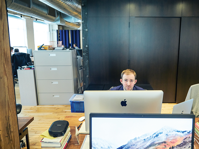 michael katchen sitting in front of his computer at wealthsimple office