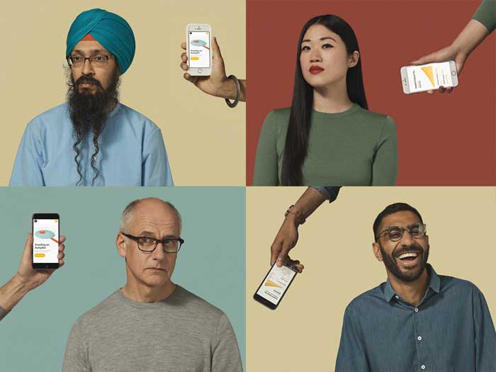 people being shown cellphones with wealthsimple website on them