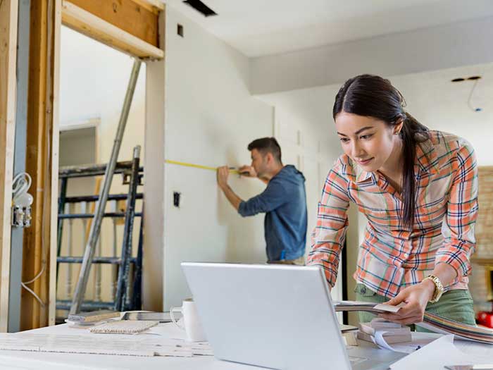 Young couple working on home renovations