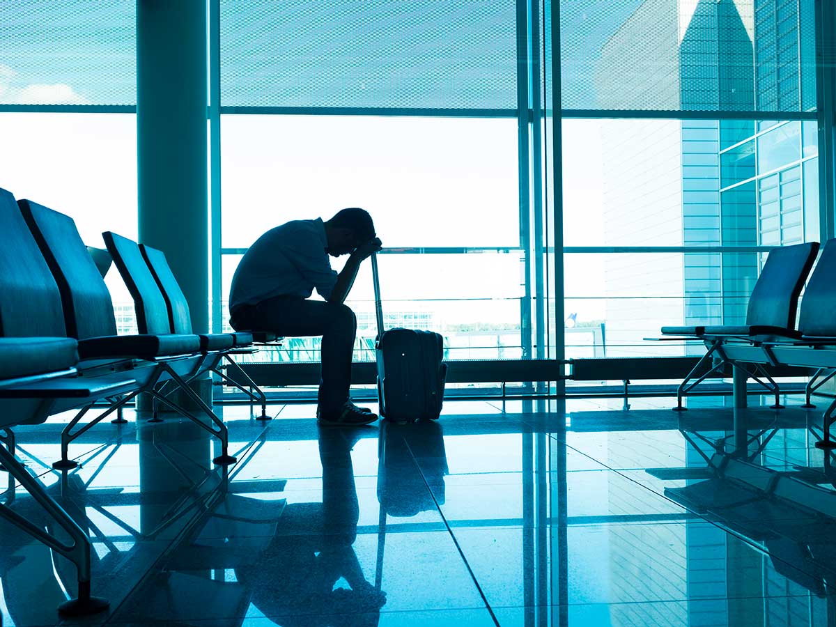 Frustrated passenger waits alone within an airport