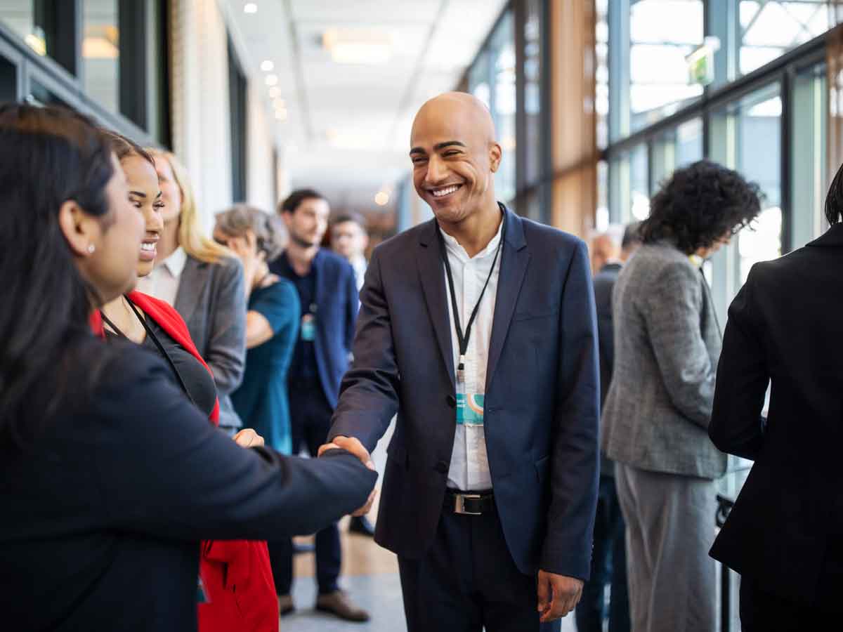Man and woman shaking hands at networking event