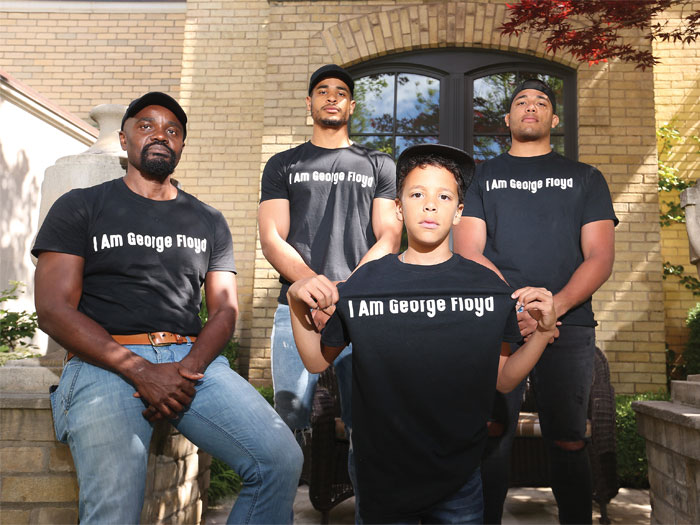 Wes Hall and his three sons wearing “I am George Floyd” t-shirts