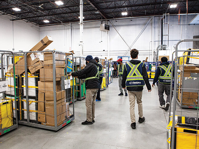 FleetOptic workers in Oakville sorting facility