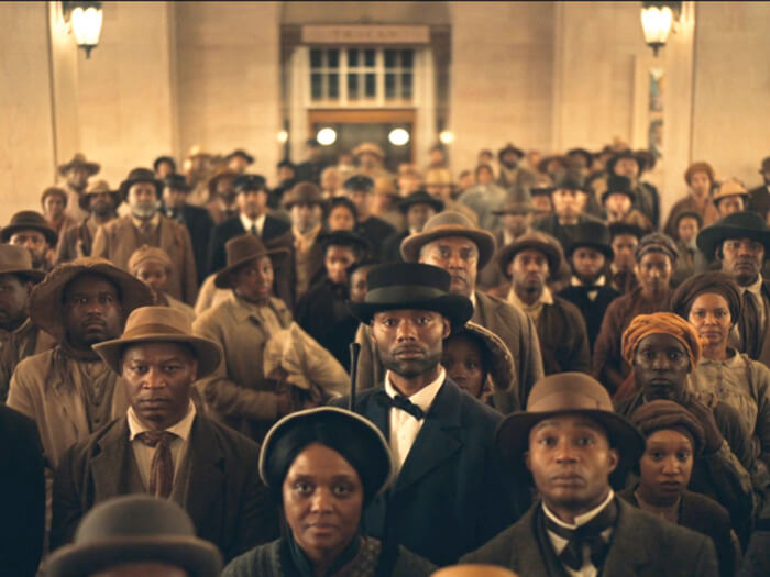 A photo from the TV series The Underground Railroad shows a large group of escaped slaves in period costume