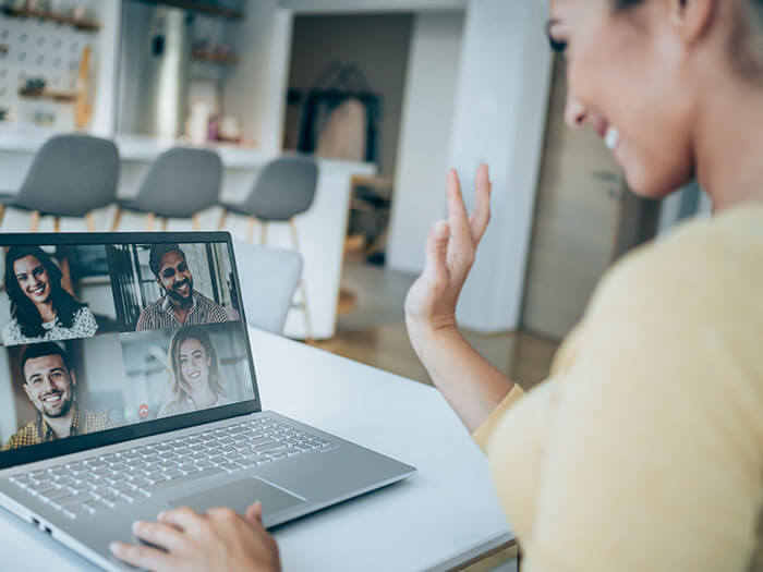 Smiling businesswoman discussing with colleagues through video call