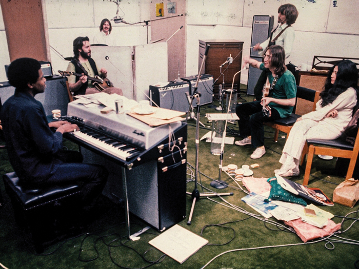The Beatles musicians are shown rehearsing in a music studio