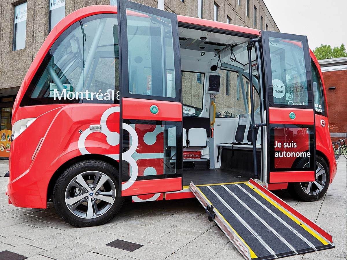 A driverless bus is shown with the doors open on a city street