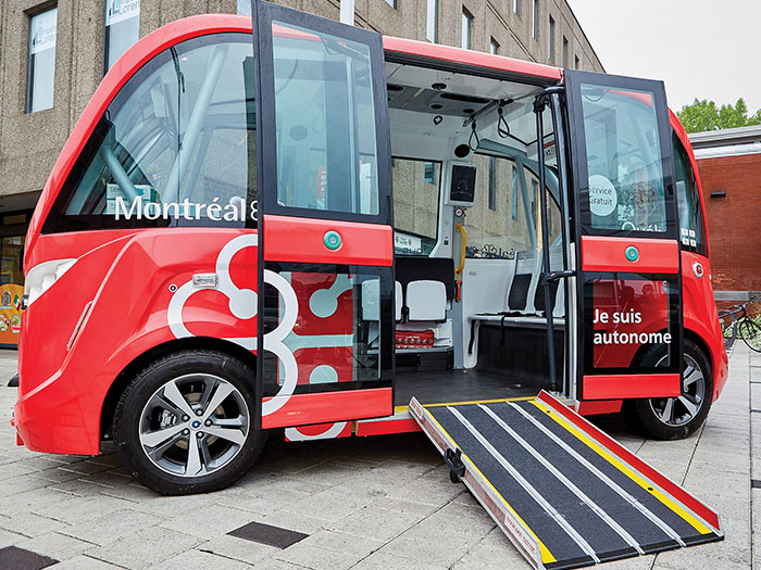 A driverless bus is shown with the doors open on a city street