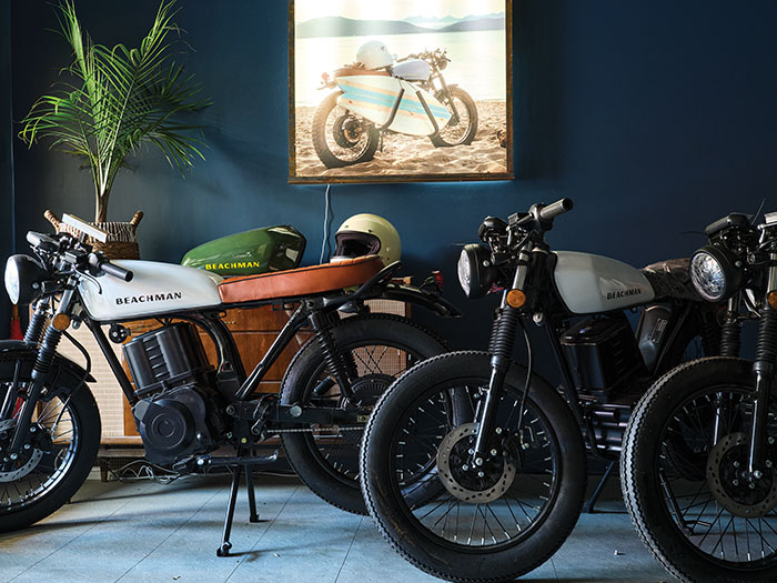 Three motorcycles are set up in a showroom