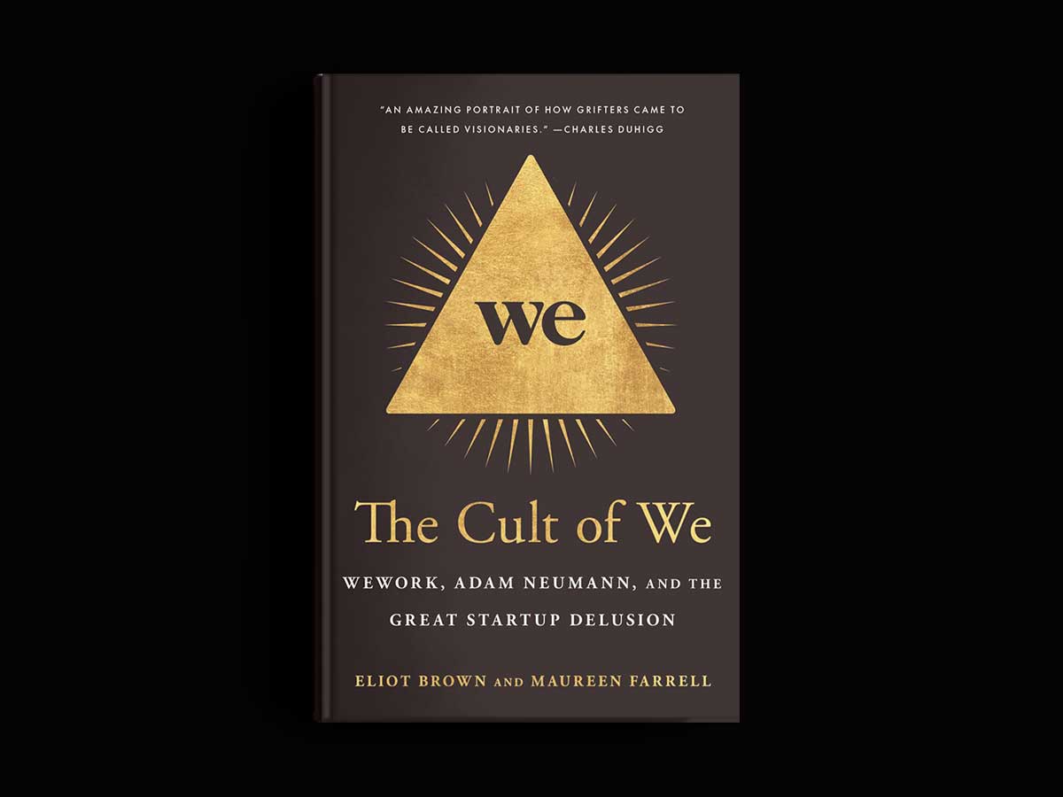The cover of a black book with a gold triangle is shown