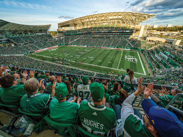 A packed stadium is shown with fans watching the Saskatchewan Roughriders play football