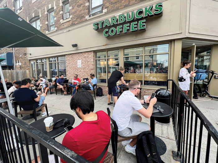 People gathering at a Starbucks during the Rogers outage to use Bell's wireless service