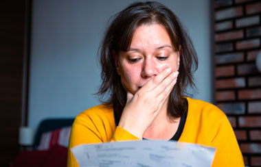 Worried woman checking bills