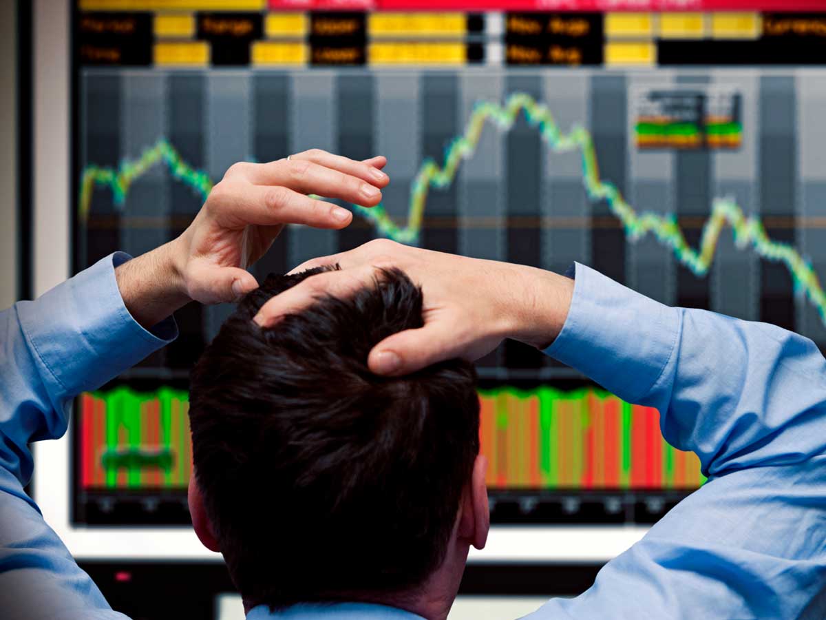 Trader watching stocks crash on screen 