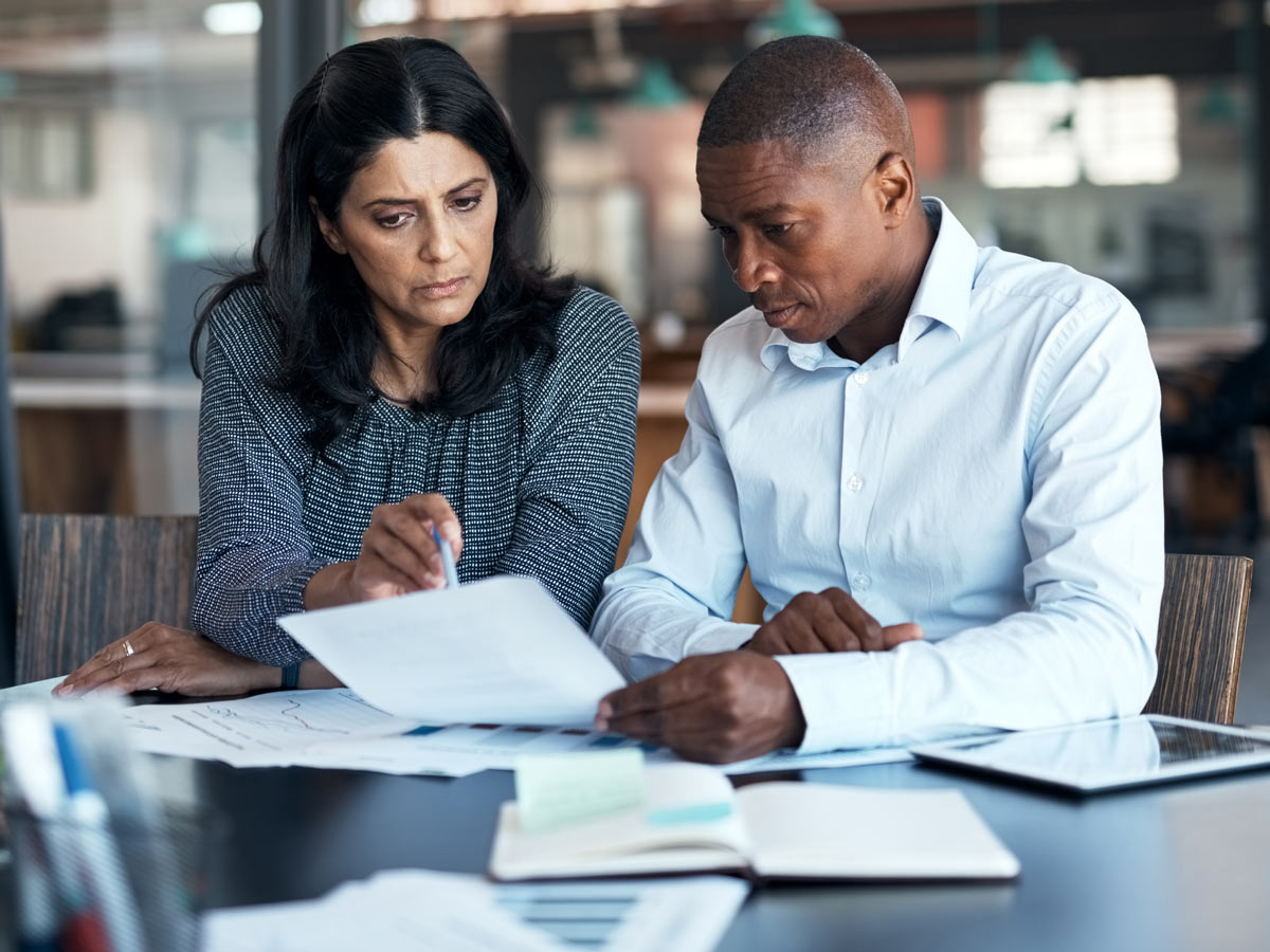Shot of a businessman and businesswoman going over paperwork 