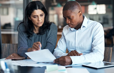 Shot of a businessman and businesswoman going over paperwork 