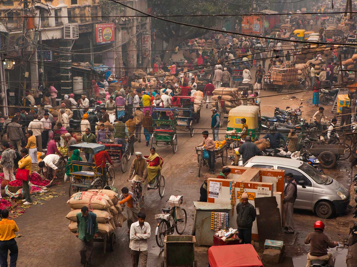 A photo of a busy street in Old Delhi shows congestion and overpopulation