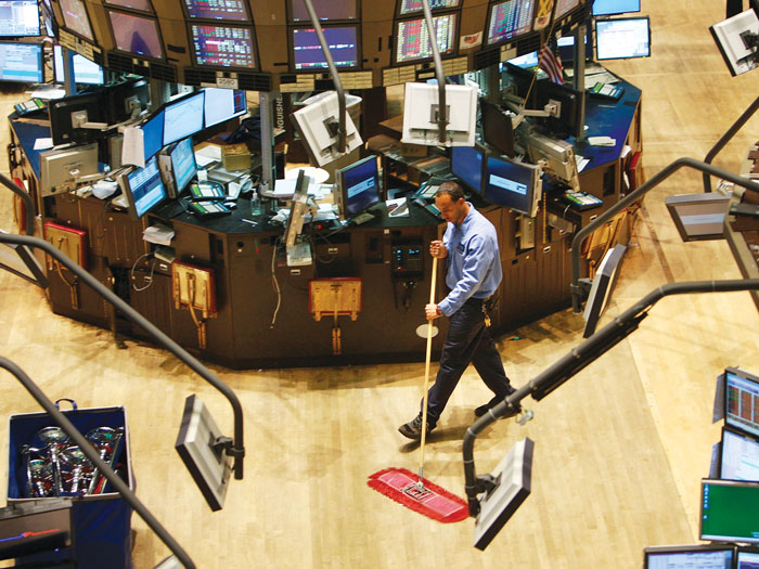 Worker sweeping floor of bank 