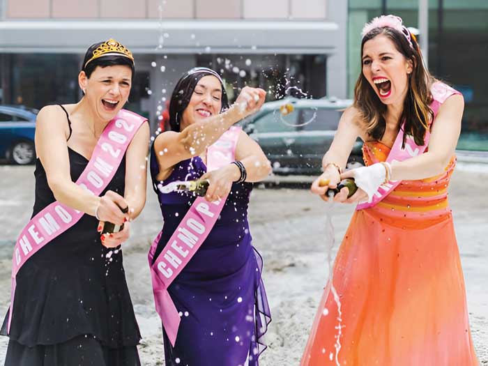 Jasmine Marcoux and two friends throw confetti at “Chemo Prom 2022”