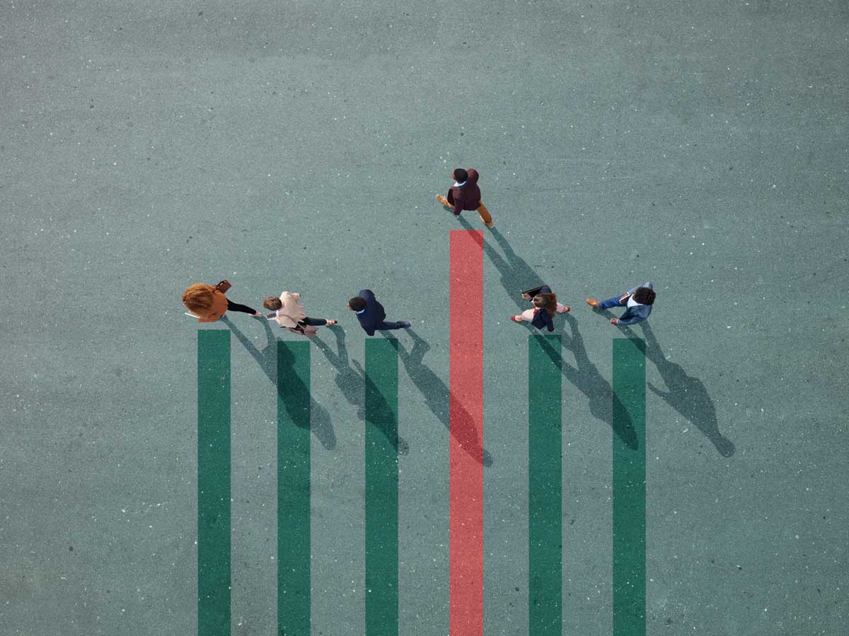 Businesspeople walking in line on bar chart painted on asphalt, one person is higher on the chart than the others