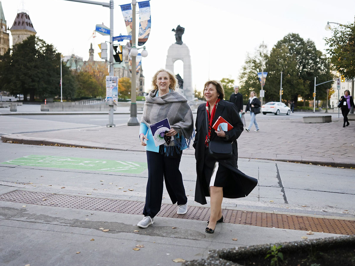 Lisa Raitt and Anne McLellan walking through the street together