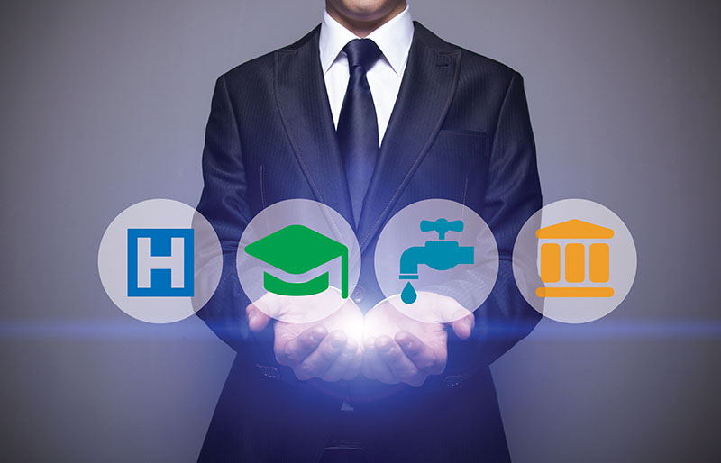 Man in suit holding hands out with light shining up from his hands to four icons for home, education, utilities and finance.