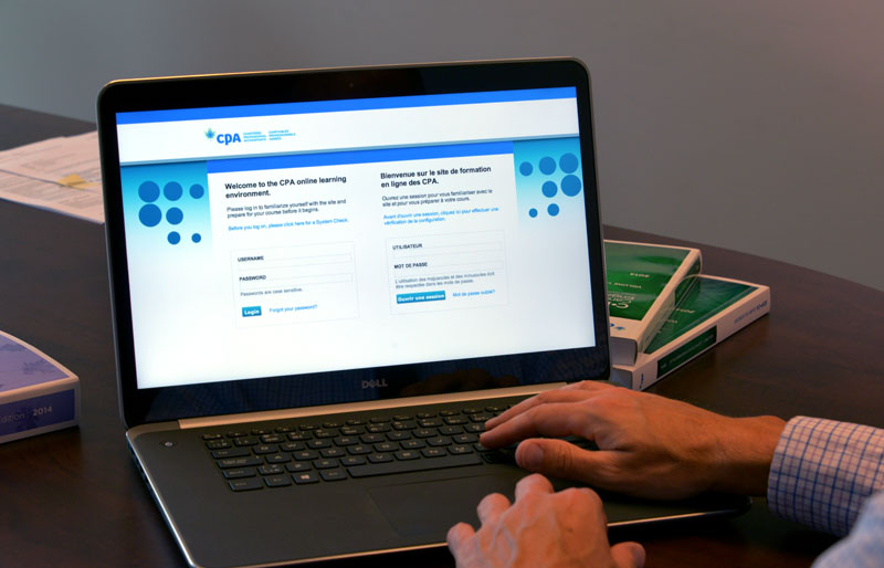 A close-up image of a business professional at his laptop logging into the CPA Canada Online Learning site. 