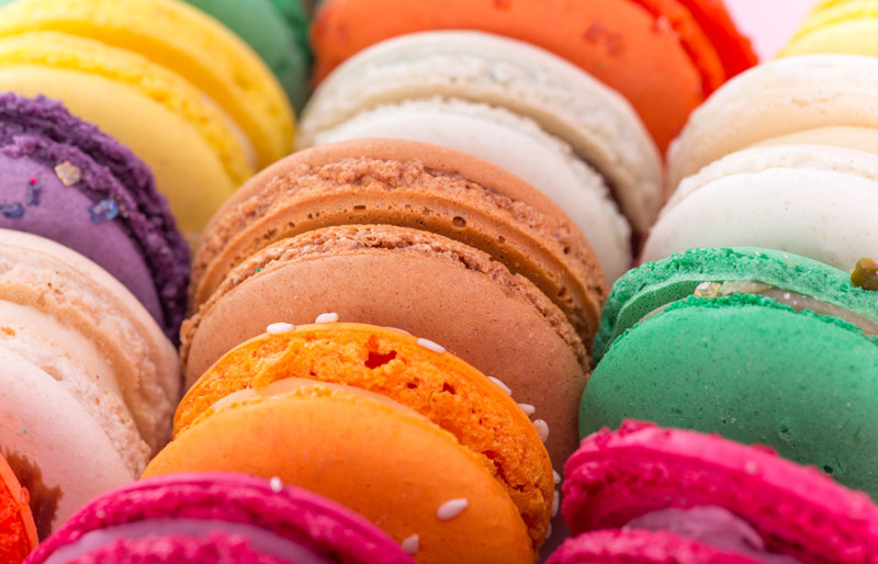 Close up of various colourful macaroons in bakery