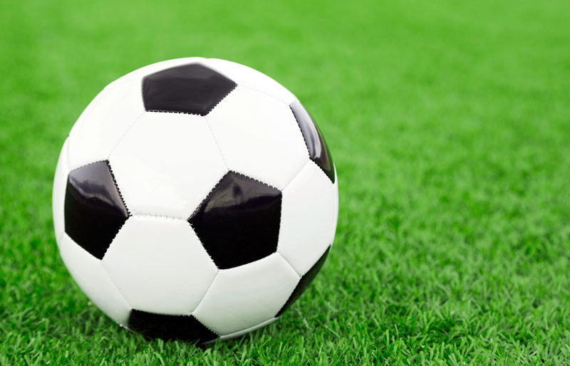 Close up of soccer ball on synthetic grass field