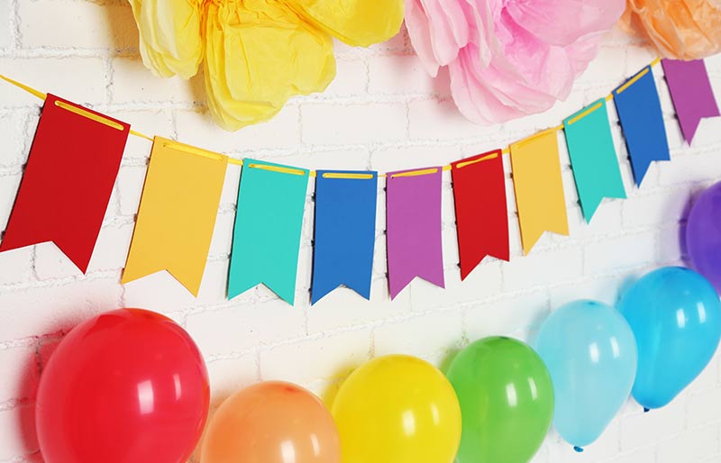 rainbow assortment of balloons and banners 