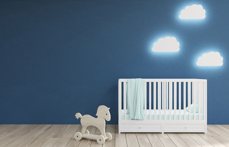 room interior with a crib, cloud shaped lamps and a toy horse
