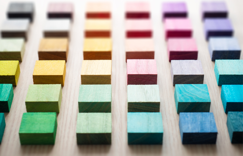 Des blocs de bois de différentes couleurs alignés en rangées.