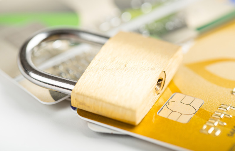 A padlock on top of credit cards.