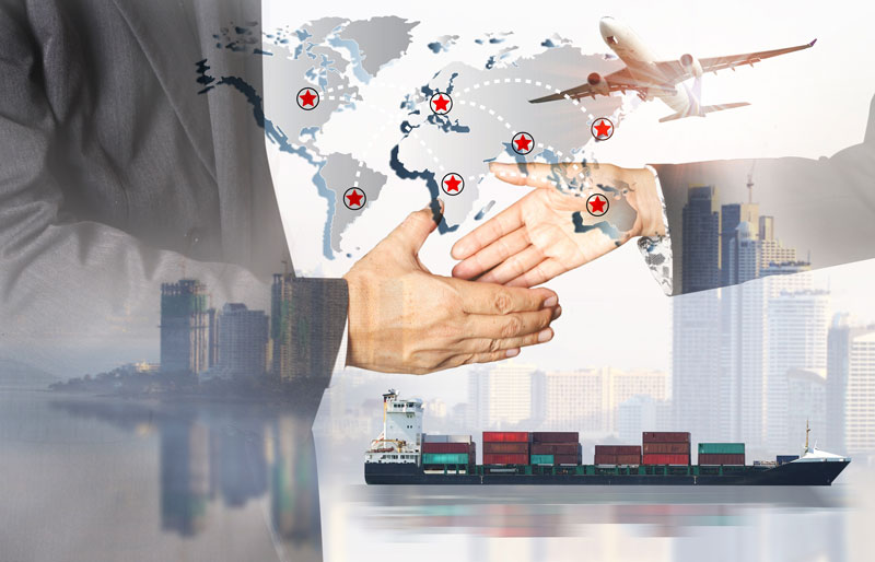 Closeup of a handshake superimposed with imagery of international business and industry.