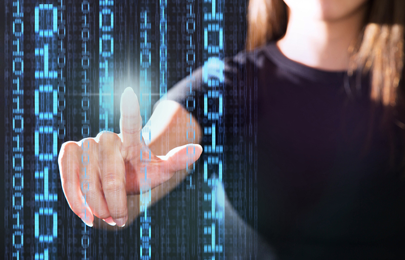 Finger of business woman touching a row of virtual binary numbers from multiple rows of virtual binary numbers 