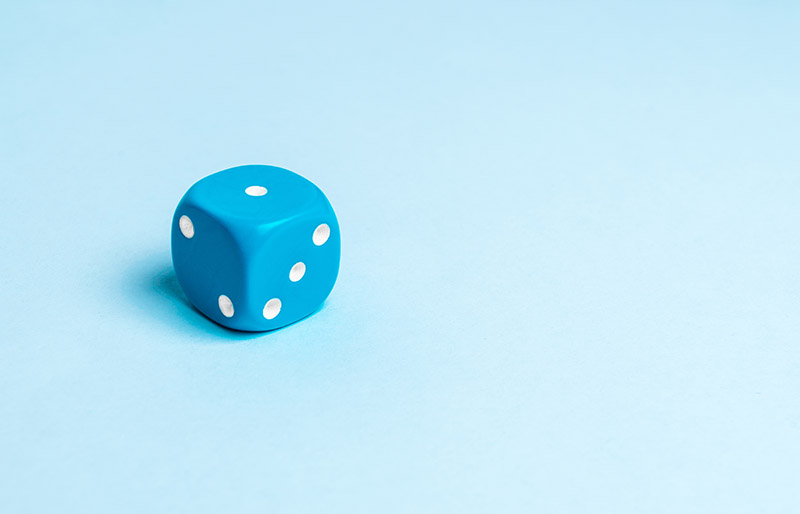 Close-Up Of Dice On Blue Background - stock photo