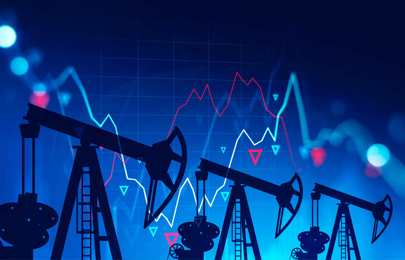 Silhouettes of industrial oil pumps on blue background with line graph superimposed.