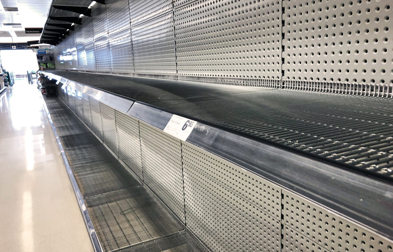 Empty rows of shelves in a retail store.