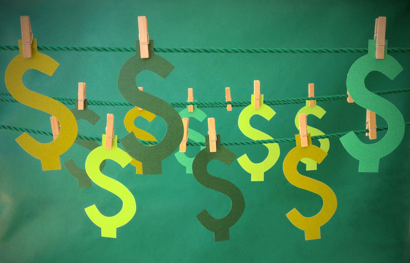Illustration of dollar signs hanging from a clothes line.