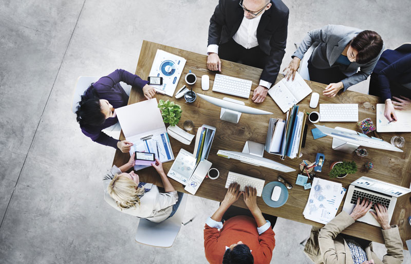 Top view of a group of business people collaborating around a table.