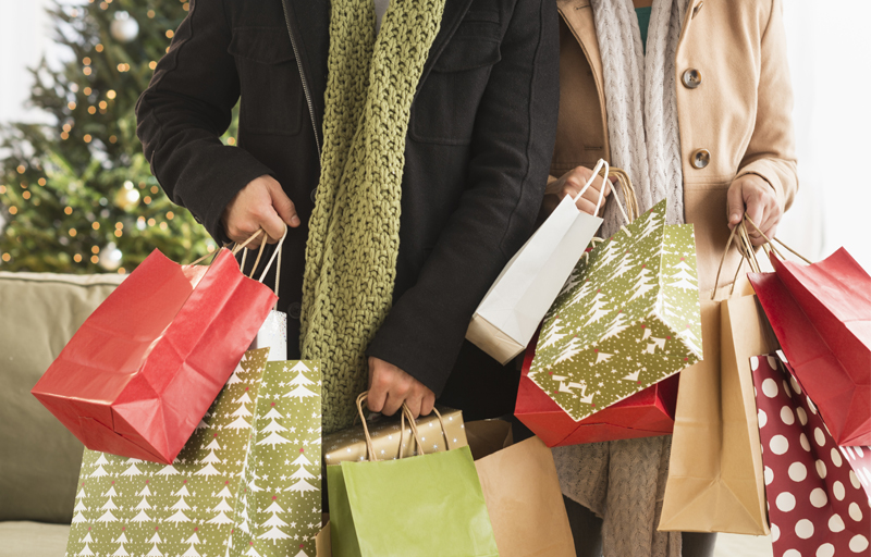 Couple holding holiday shopping bags