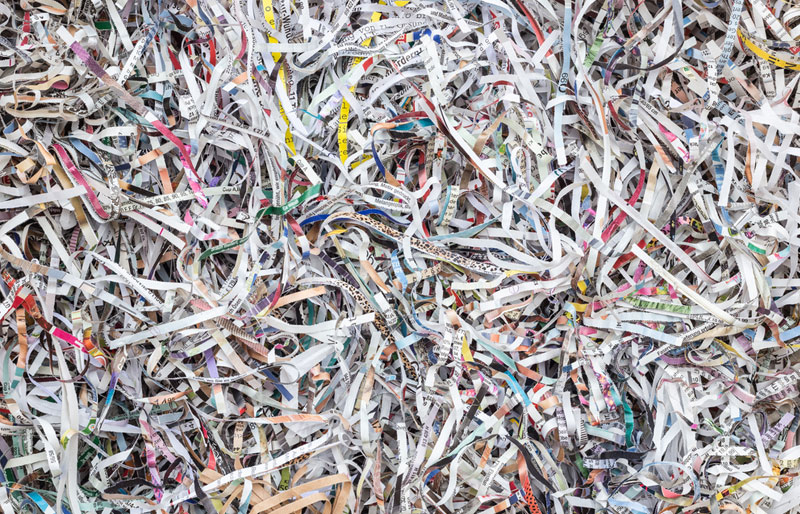 A close-up cropped image of shredded paper records. 