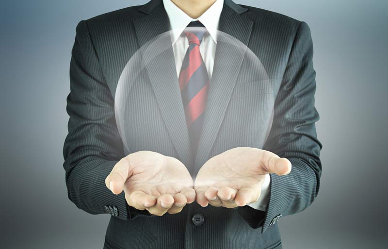 Business professional holding a transparent ball. 
