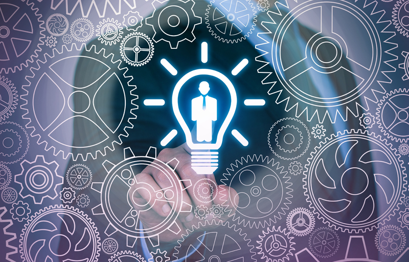 Business person touching a lightbulb icon in center, surrounded by virtual gears interlocked