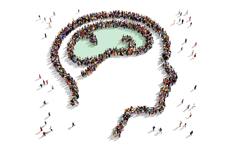 Vue plongée d’un groupe de personnes formant un cerveau à l’intérieur du profil d’une tête.