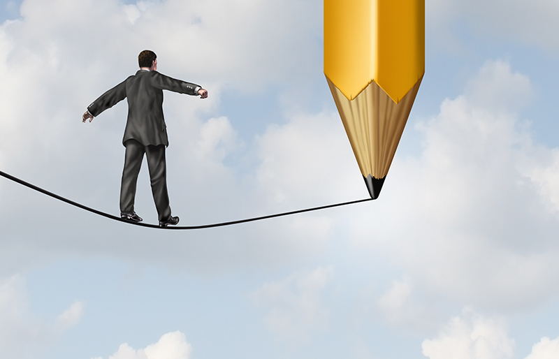 Illustration of a business person walking a tightrope, still being drawn by a large pencil