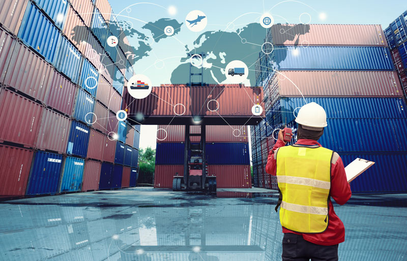Dockyard employee scans shipping containers, world map and icons superimposed.
