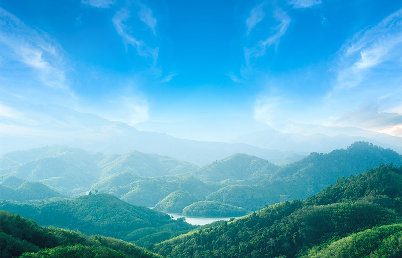 World environment day concept: Green mountains and beautiful blue sky clouds