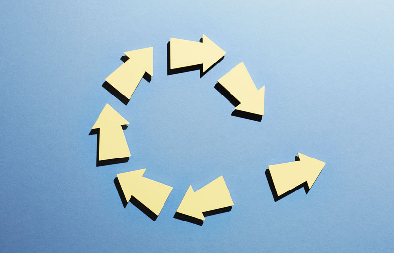 A group of arrows moving in a circle with one arrow breaking away.