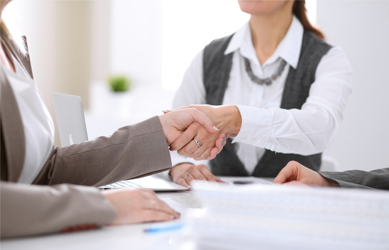 Business woman and client shaking hands